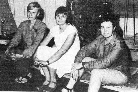 Darani Lewers, Tanya Crothers and Jan Birmingham (left to right) sitting on a section of the 'duck board' whihc weaves through their installation 'Peace and Nuclear War in the Australian Lanscape'. - Photo: Mark Roberts